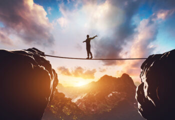 Man walking on rope between two high mountains at sunset. Concept of taking a risk, adventure, motivation. 3d illustration